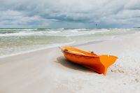 Kaboompics - Orange Boat on a Sandy Beach with Baltic Sea Waves