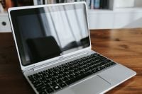 Kaboompics - Close-Up of Silver Laptop Screen and Keyboard on a Wooden Table