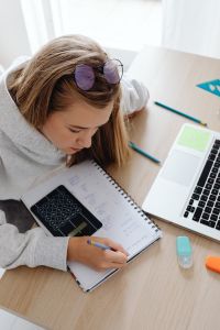 Kaboompics - Close Up of Student Writing Math Notes at Desk
