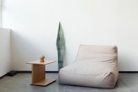 Kaboompics - Minimal Beige Armchair with Wooden Side Table