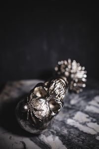 Kaboompics - Close-Up Silver Skull on Marble with Blurred Background