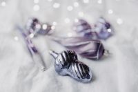 Kaboompics - Blurred Silver and Violet Ornaments on Light Fabric