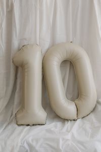 Kaboompics - White Inflatable Number Balloons and Cake on Bedding