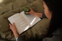 Kaboompics - Woman Reading in Bed during a Cozy Morning