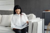 Kaboompics - Woman Relaxing with Reading Material on a Sofa