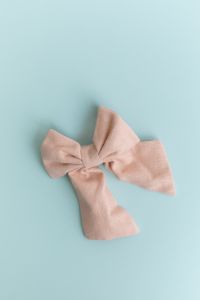 Kaboompics - Pastel fabric bow on light blue background minimal still life
