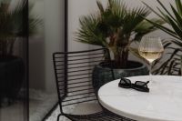 Kaboompics - Rainy Day Patio Table With White Wine and Sunglasses