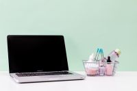 Kaboompics - Laptop and Shopping Basket with Beauty Products on Mint Green Background