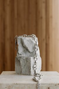 Kaboompics - Silver Chain on Stacked Stone Blocks