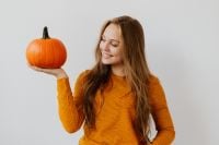 Kaboompics - Young Woman Holding Pumpkin on Palm