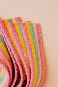 Kaboompics - Rainbow Sour Candy Belts Clustered in the Lower Left with Copy Space