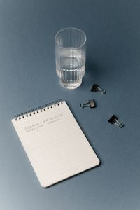 Kaboompics - Minimal Office Desk With Notebook Glass And Binder Clips