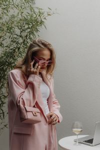 Kaboompics - Woman Wearing Pink Sunglasses Beside a Laptop and Wine Glass