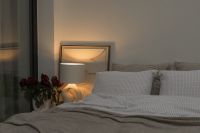 Kaboompics - Warm Bedside Lamp and Flowers in a Cozy Bedroom