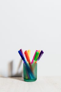 Kaboompics - Bright Markers in a Glass Holder Against White Space for Classroom and Study Workspace
