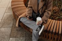 Kaboompics - Cropped Woman Holding Coffee and Phone on a City Bench