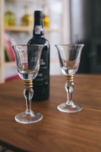 Kaboompics - Two empty wine glasses with a bottle of wine on a table