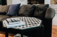 Kaboompics - Art Books on Geometric Marble Table Beside Black Sofa