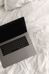 Kaboompics - Overhead Laptop on White Cotton Sheets for Remote Work
