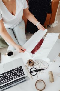 Kaboompics - Rust-Colored Knit Sweater Packed in Tissue Inside a White Shipping Box