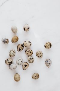 Kaboompics - Speckled Quail Eggs on White Marble with Open Copy Space, Easter Background