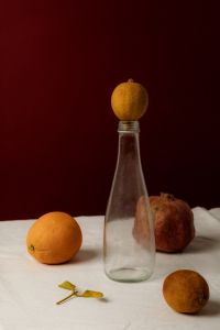 Kaboompics - Moody Citrus Still Life with Lemon on Bottle and Pomegranate