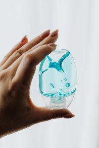 Kaboompics - Blue Travel Sanitizer Bottle Held Against Bright Window