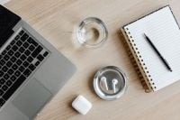 Kaboompics - Top View of Laptop, Water Glass, AirPods and Notebook