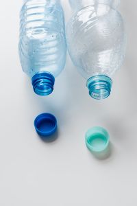 Kaboompics - Two Uncapped Plastic Bottles with Caps Below