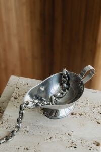 Kaboompics - Silver Chain Arranged in a Metal Bowl