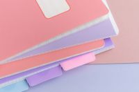 Kaboompics - Pastel Notebook Stack on Pink Background