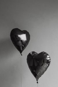 Kaboompics - Black Heart-Shaped Balloons in Moody Monochrome Light
