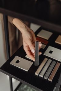 Kaboompics - Hand Presenting Dark Grout Sample for Interior Finish Selection