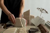 Kaboompics - Hands Arranging Mixed Stone Samples on a Neutral Table