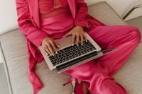 Kaboompics - Overhead Laptop Work on Sofa in Pink Satin Suit