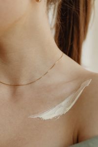 Kaboompics - Bare Shoulder with a Streak of Body Moisturizer in a Minimal Skincare Photo