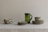 Kaboompics - Green Splatter Tableware Arrangement with Glass Pitcher on Linen