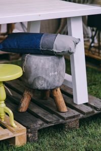 Kaboompics - Grey stool with a pillow by a table