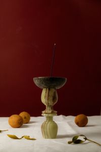 Kaboompics - Incense Stick in Vintage Glass Holder with Citrus and Burgundy Backdrop