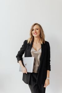 Kaboompics - Businesswoman in Black Blazer with Laptop Against White Background