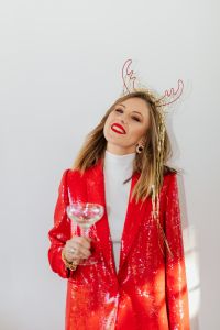 Kaboompics - Woman Smiling under Gold Tinsel with a Champagne Coupe