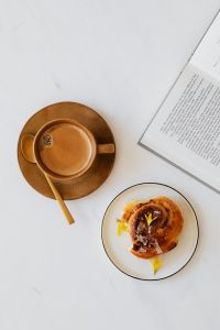 Kaboompics - Vertical Coffee, Cinnamon Roll and Book Still Life