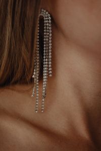 Kaboompics - Woman Wearing Long Gold Chain Earrings Close-Up
