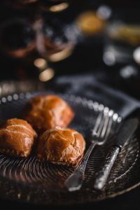 Kaboompics - Close View of Three Sweet Buns and Coffee on a Dark Table