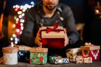 Kaboompics - Man Holding Small Gift Box in Warm Holiday Atmosphere
