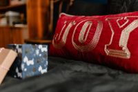 Kaboompics - Red Joy Pillow and Small Wrapped Gifts