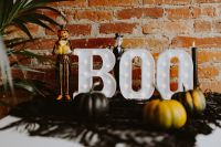 Kaboompics - Wide Halloween Table Display with BOO Marquee and Jack-o'-Lanterns