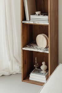 Kaboompics - Neutral Bookcase Decor with Marble Shelves and a Linen Curtain