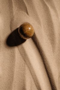 Kaboompics - Brown Round Stone Casting a Shadow on Sand
