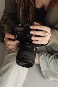 Kaboompics - Close Up of DSLR Camera in Young Photographer Hands